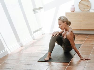 An empty, serene room prepared for a yoga session.